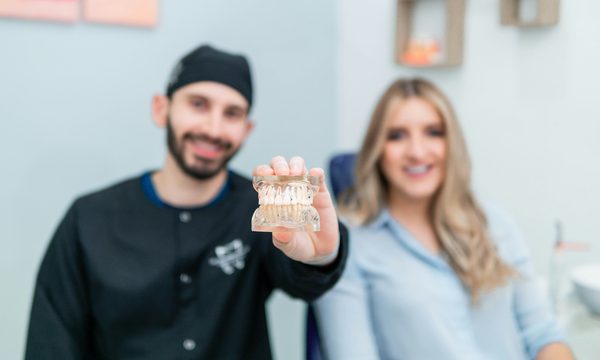 Dentist showing a patient a clear aligner model during a cosmetic consultation